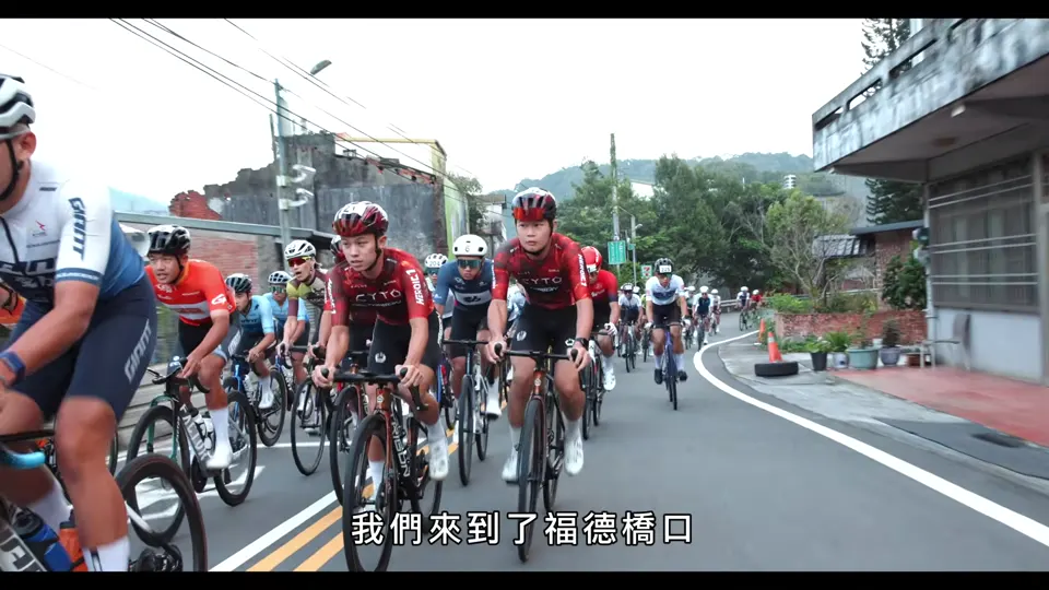 男子菁英集團在村落道路上並排騎行。